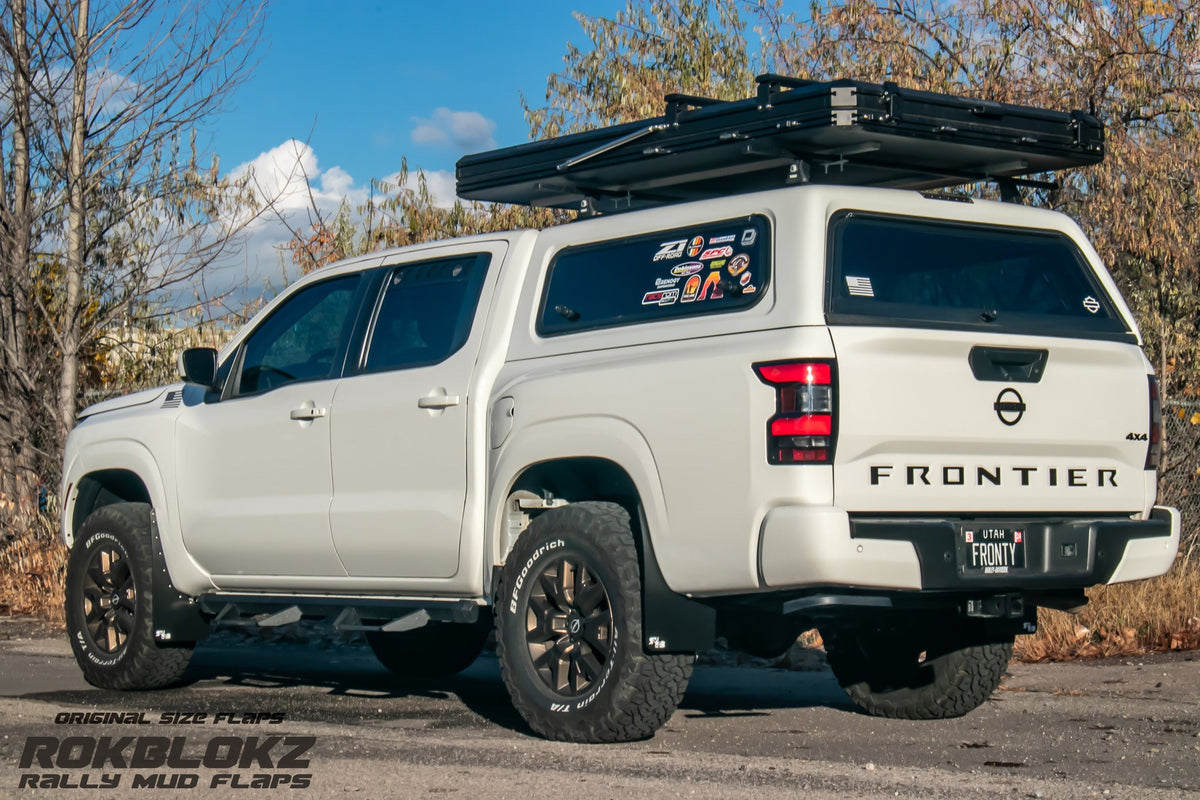 22+ Nissan Frontier SV Featuring Rokblokz Mud Flaps in Black - 3/4 view