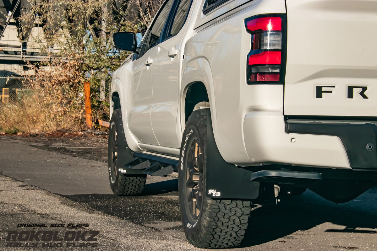 22+ Nissan Frontier SV Featuring Rokblokz Mud Flaps in Black - Driver side